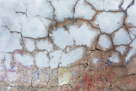 Old cracked concrete with paint residuesの写真素材