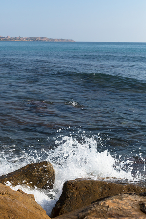 Big breaking Sea wave on a sandy beachの写真素材