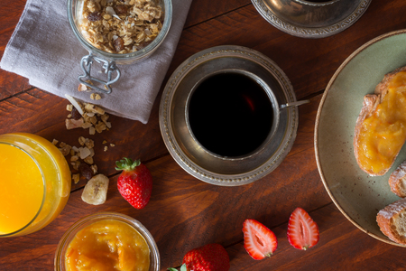 Traditional european breakfast. Coffee, jam and berries on the wooden tableの写真素材