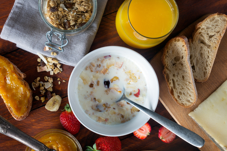 Traditional european breakfast. Bread,milk and granola on the wooden tableの写真素材