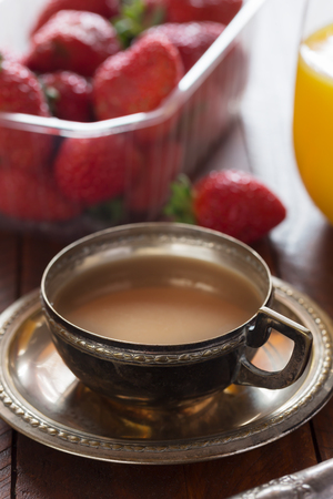 Traditional european breakfast. Coffe woth milk and berries on the wooden tableの写真素材