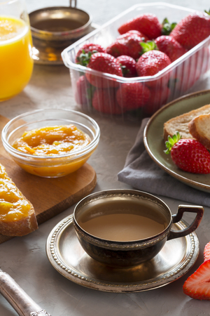 Traditional european breakfast. Bread, jam and berries on the wooden tableの写真素材
