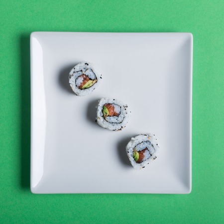 Japanese sushi on a green background. Square shape