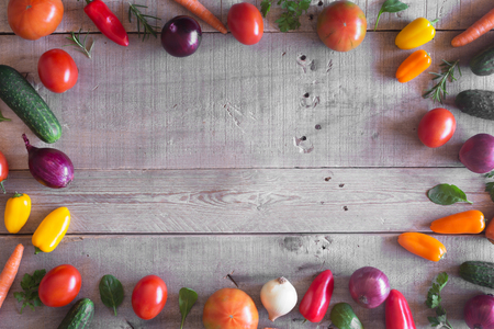Fresh organic vegetables on a wooden background. Top viewの写真素材