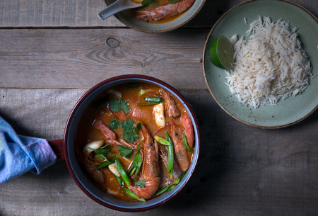 Traditional Thai soup Tom Yam prepared with shrimps, calamari and herbsの写真素材