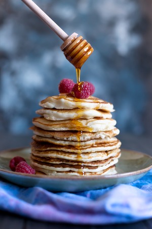 Pancakes with berries and honの写真素材