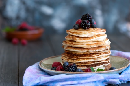 Pancakes with berries and honeyの写真素材