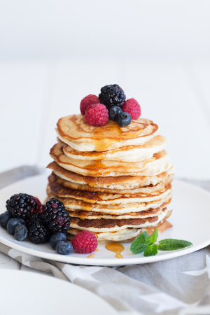 Pancakes with berries and honeyの写真素材