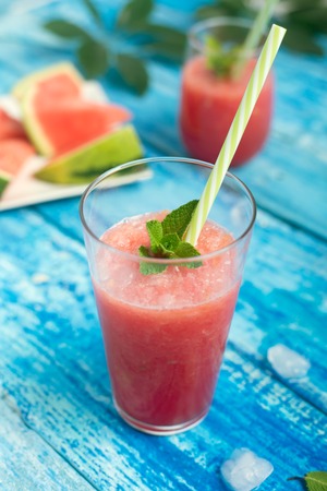 Fresh watermelon smoothie in two glasses with mint prepared to drinkの写真素材