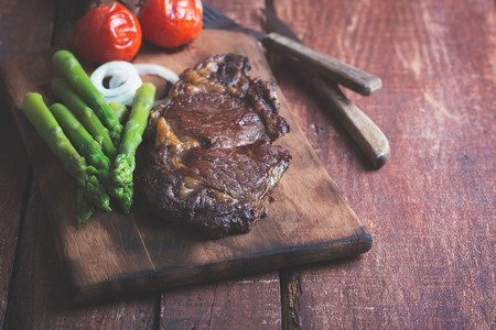 Grilled beef steak on a wooden rustic backgroundの写真素材