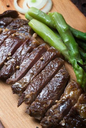 Grilled beef steak on a wooden rustic backgroundの写真素材