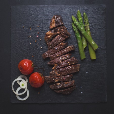 Grilled beef steak on a black backgroundの写真素材
