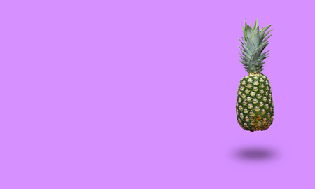 Pineapple on purple background. Minimal style with copy space for textの写真素材