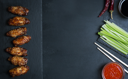 Traditional Asian chicken wings in sweet and sour sauce with sesameの写真素材