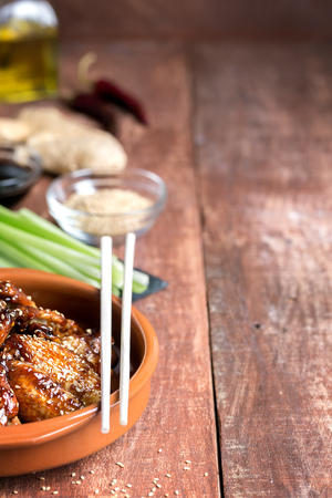 Traditional Asian wings in sweet and sour sauce with sesameの写真素材