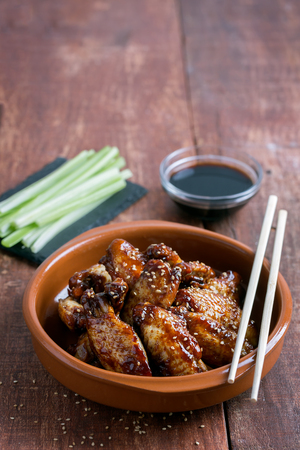 Traditional Asian wings in sweet and sour sauce with sesameの写真素材