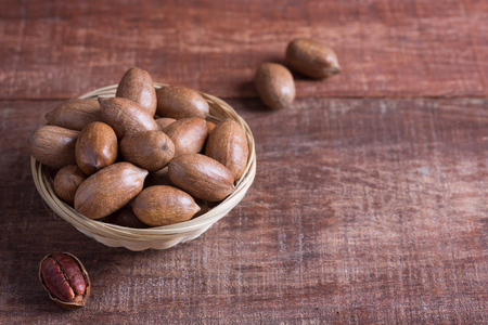 Pecan nuts on a wooden table with copy spaceの写真素材