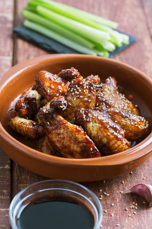 Traditional Asian wings in sweet and sour sauce with sesame. Close up shotの写真素材