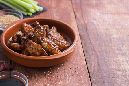 Traditional Asian wings in sweet and sour sauce with sesame. Horizontal orientationの写真素材