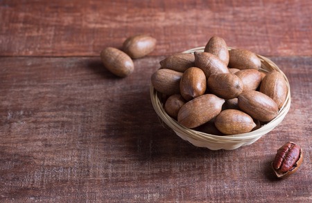 Pecan nuts on a wooden table with copy spaceの写真素材