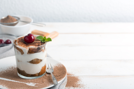 Tiramisu and cherry in a glass cupの写真素材