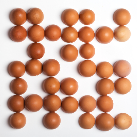 Pattern made of brown eggs on white background. Food conceptの写真素材