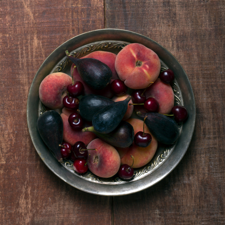 Fruits on the dark wooden table. Top viewの写真素材
