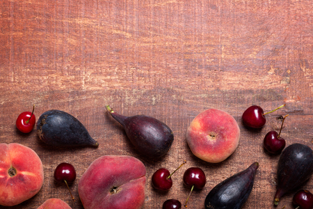 Fruits on the dark wooden table with copy spaceの写真素材
