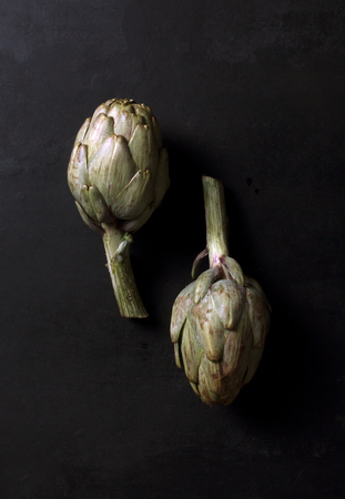 Fresh artichokes on dark backgroundの写真素材