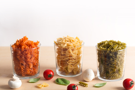 Different types of Italian pasta with vegetables on the tableの写真素材