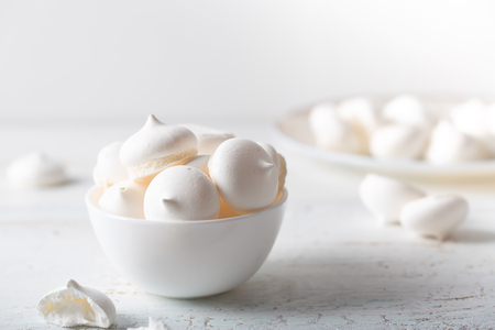 Meringues dessert on white wooden table, side viewの写真素材