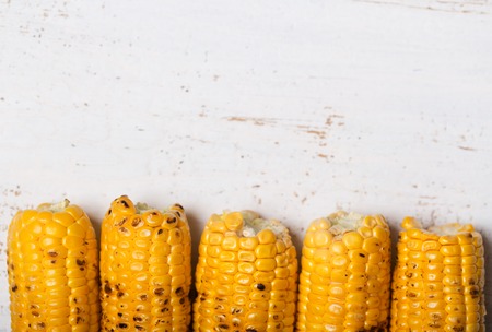 Grilled corn cobs on the white rusticの写真素材