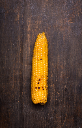 Grilled corn cob on the brown rusticの写真素材