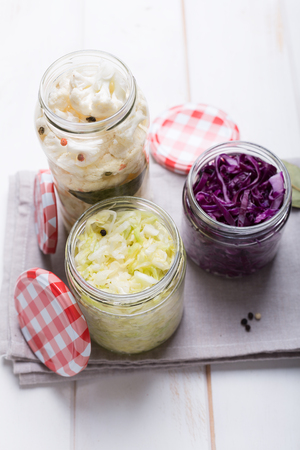 Sauerkraut in jars on a wooden table. Top viewの写真素材