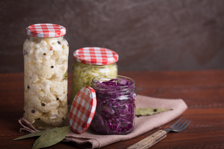 Sauerkraut in a blue bowl on a wooden table. Copy spaceの写真素材