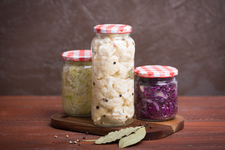 Sauerkraut in a blue bowl on a wooden tableの写真素材