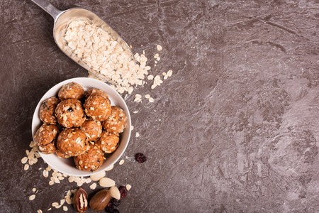 Healthy organic energy granola bolls with nuts, cacao, oats and raisins - vegetarian sweet bites without sugar.の写真素材