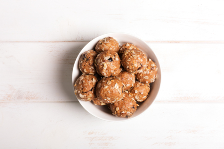 Healthy organic energy granola bolls with nuts, cacao, oats and raisinsの写真素材