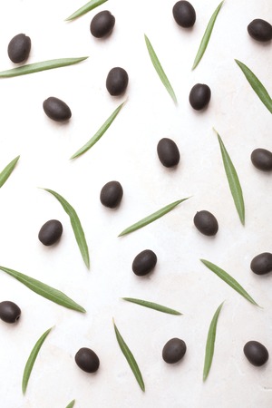 Olives and its leaves on a whiteの写真素材