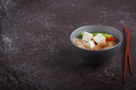 Traditional spicy asian soup with tofu cheese and noodles. This dish usually contains bouillon and vegetablesの写真素材