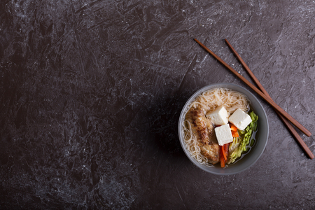 Traditional spicy asian soup with tofu cheese and noodles.の写真素材