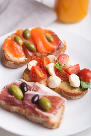 Sandwiches or tapas on the plate prepared with bread and tasty ingredients. Could be nice food for healthy breakfast ot lunchの写真素材