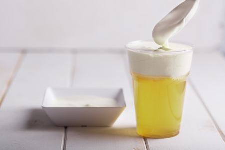 A plastic glass of cheese tea with layer of creamy foam. Traditional Chinese Asian Beverageの写真素材