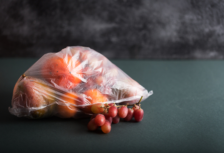 Fruits in plastic bags on a blackの写真素材