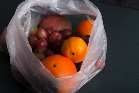 Fruits in plastic bags on a blackの写真素材