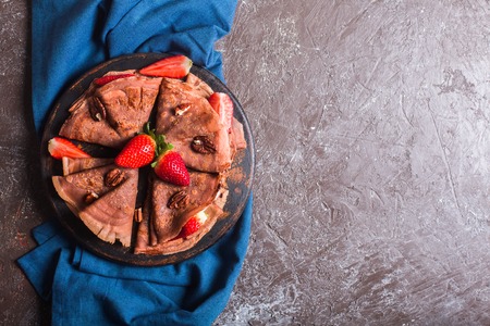 Traditional French crepes cooked with chocolate. Decorated with mint and strawberriesの写真素材
