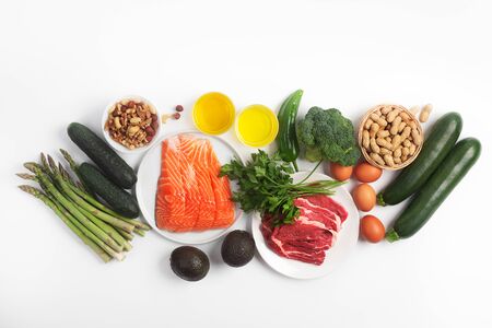 Ketogenic, keto diet, including vegetables, meat and fish, nuts and oil isolated on white background, horizontalの写真素材