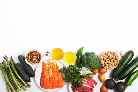 Ketogenic, keto diet, including vegetables, meat and fish, nuts and oil isolated on white background, horizontal with copy spaceの写真素材