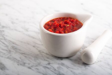 Traditional Maghrebi hot chili pepper sauce paste harissa. Tunisia and Arabic cuisine adjika. Image contains copy spaceの写真素材