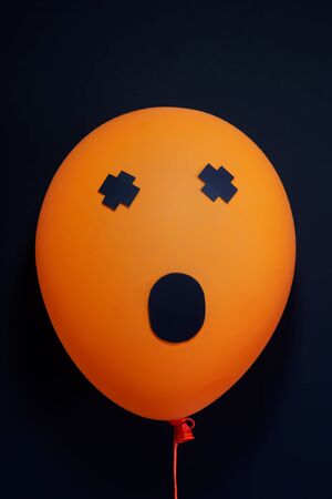 Autumn holidays decoration and party concept - scary air balloons for halloween over black...